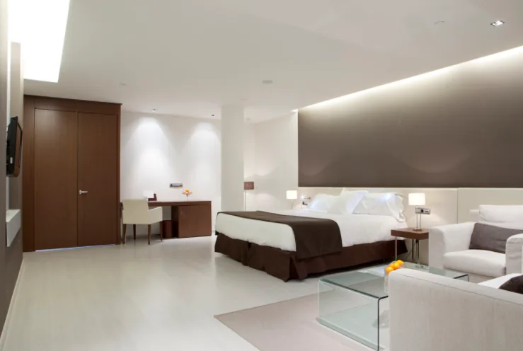 Habitación de hotel terminada con cabecero retroiluminado